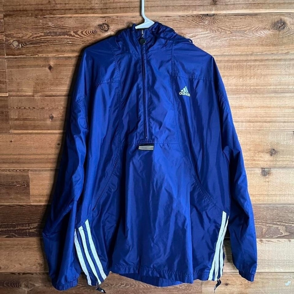 Adidas navy blue windbreaker jacket with white stripes and hood.